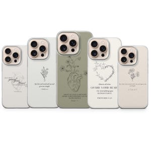 Puede incluir: Una colección de fundas para teléfonos con varios diseños y citas. Las fundas presentan ilustraciones florales y de corazón anatómico en negro sobre un fondo blanco o verde oliva. Cada funda tiene un protector de lente de cámara transparente.