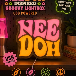May include: A NeeDoh branded lightbox featuring pink and orange illuminated lettering. The sign displays the text NeeDoh, Groovy Glow Good Vibes Only, and USB Powered. It includes icons for USB power, energy efficiency, soft glow, and retro vibes.