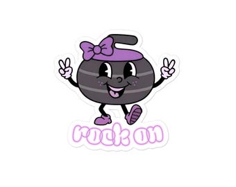May include: A sticker featuring a cartoon curling stone with a purple bow and hat. The stone has a smiling face and is giving the peace sign with both hands. The words "rock on" are written in a pink font.