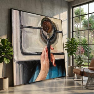 May include: An oil painting depicts a hand with red nail polish holding a coffee pot over a stove burner. The painting has a black frame and is set in a room with large windows and potted plants. The color palette includes white, black, brown, and blue.