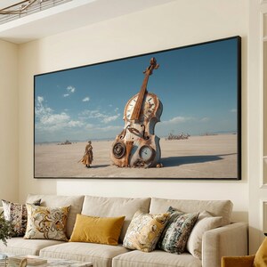 May include: A framed artwork shows a surreal scene featuring a giant violin-shaped clock in a desert landscape under a blue sky. A person stands near the clock. The artwork is displayed above a sofa with decorative cushions.