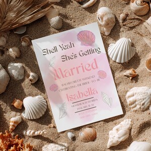 May include: A white invitation card with pink text and seashell illustrations, surrounded by seashells on sand. The text reads "Shell Yeah She's Getting Married" and announces a bachelorette weekend in Miami Beach for Isabella.