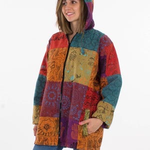 May include: A colourful patchwork hooded jacket with a full-length zip and two front pockets. The jacket features a variety of colours, including red, orange, purple, and teal. The hood is also patchwork, and the fabric appears to be soft and textured.