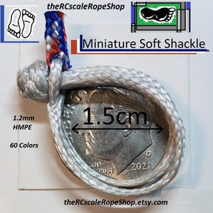 May include: A miniature soft shackle made of gray rope, measuring 1.5cm in diameter, is shown next to a US dime. The rope is 1.2mm HMPE and available in 60 colors. The text "Miniature Soft Shackle" is visible.