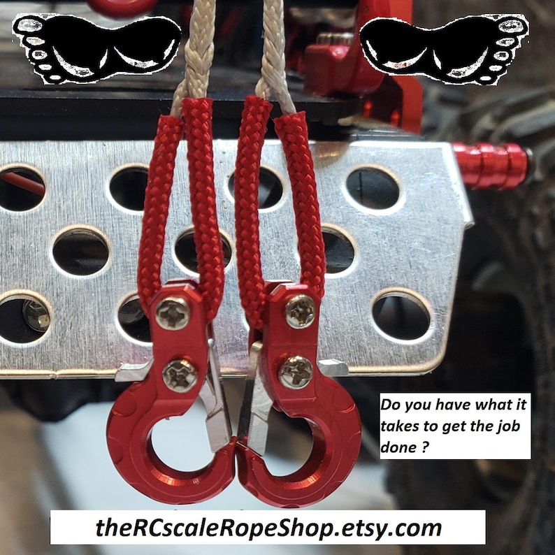 May include: Close-up of red metal hooks with silver accents, connected to red braided rope. The hooks are attached to a silver metal plate with circular cutouts. Text on the image reads: "Do you have what it takes to get the job done?" and "theRCscaleRopeShop.etsy.com".