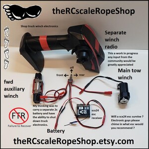May include: An overhead shot of RC truck winch electronics, including a black and red radio controller, a main tow winch, and an auxiliary winch. Text includes "Separate winch radio" and "theRCscaleRopeShop.etsy.com".