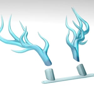May include: A pair of light blue antlers with a silver base. The antlers are made of a smooth, shiny material and have a delicate, intricate design.