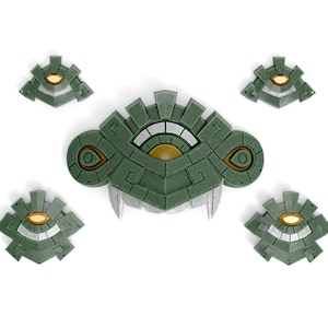 Op de afbeelding: Set van vijf groene en gouden 3D-geprinte wanddecoraties met een gestileerd oogontwerp. De stukken zijn geïnspireerd op het Oog van de Triforce uit de Legend of Zelda-videogameserie.