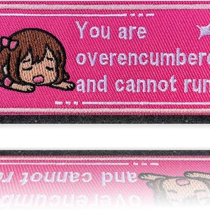 May include: A pink embroidered patch with the text "You are overencumbered and cannot run!" features a cartoon character with brown hair and a pink bow. The patch has a white border and a black backing.
