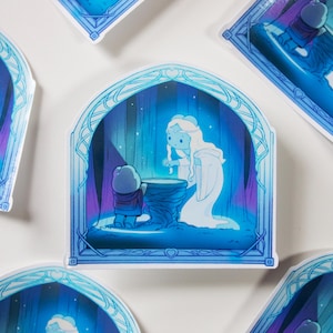May include: A blue and white sticker with a whimsical illustration of a small figure in a red and brown outfit standing in front of a glowing figure in a white dress. The scene is set in a forest with a blue and purple sky. The sticker is framed with a blue and white border.