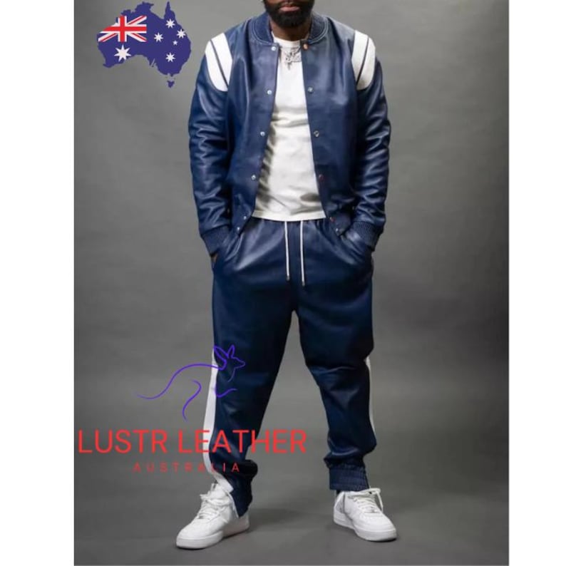 May include: A navy blue leather bomber jacket with white shoulder stripes and matching navy blue leather pants with white side stripes. The outfit is paired with white sneakers. The image includes the text "LUSTR LEATHER AUSTRALIA".