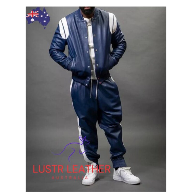 May include: A navy blue leather bomber jacket and matching pants with white stripes. The jacket has white shoulder accents and a button-up front. The pants have a drawstring waist. The outfit is paired with white sneakers. The text "LUSTR LEATHER AUSTRALIA" is visible.
