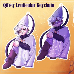 May include: A Qifrey lenticular keychain featuring an anime-style character with white hair, round glasses, and a pointed hat. The character wears a light purple cloak and dark boots. A gold-colored lobster clasp is included in the upper right corner.