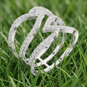 Close up of F color VS clarity lab diamond facets and symmetrical pave work on 10k gold triple band ring