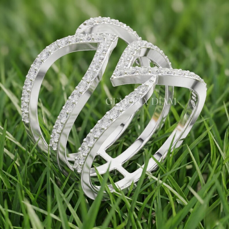 Close up of F color VS clarity lab diamond facets and symmetrical pave work on 10k gold triple band ring