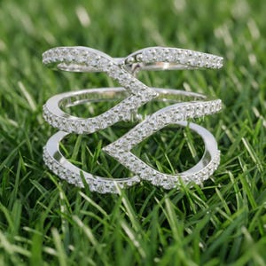 Modern multi-row wide band ring in 14k white gold featuring round lab grown diamonds in a geometric pave setting.