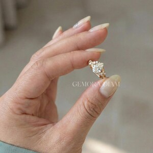 Sterling silver pear promise ring for her, perfect anniversary gift or birthday present shown in natural outdoor lighting.