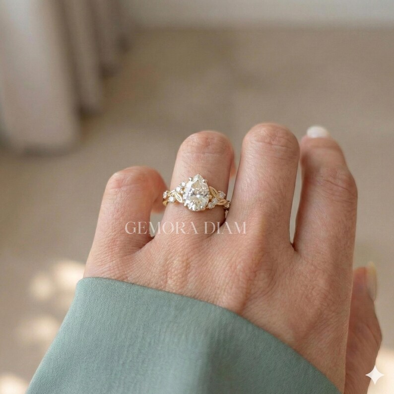 Women's pear cut ring shown on finger for scale, true to size fit in 14k yellow gold for a modern bridal look