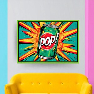 May include: Framed pop art print of a green soda can with the word "POP!" in a red circle. The background is a burst of yellow, orange, and red. The artwork is displayed above a yellow sofa, adding a vibrant touch.