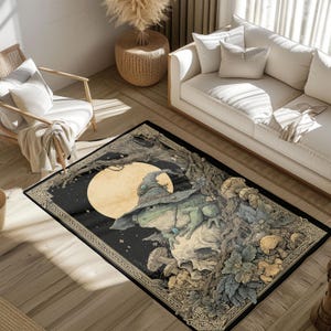 May include: A rectangular area rug featuring a whimsical illustration of a frog wearing a witch's hat, perched atop a skull. The design includes a full moon, trees, and mushrooms, with a dark border.