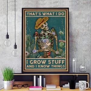 May include: A framed poster featuring a skeleton wearing a sombrero and holding a pot of flowers. The poster has the text "THAT'S WHAT I DO" at the top and "I GROW STUFF AND I KNOW THINGS" at the bottom. Cacti and birds are also featured.