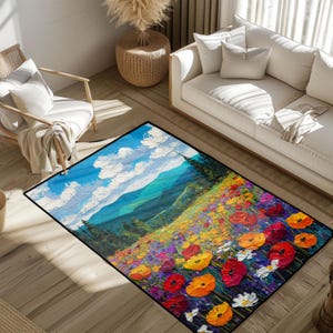May include: A rectangular rug with a landscape painting design. The artwork shows a blue sky with white clouds, green hills, and a field of flowers in red, orange, yellow, and purple. The rug is suitable for a living room.