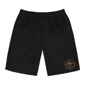Sword Club Board Shorts | Black swim trunks with circular emblem