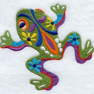 May include: A green embroidered frog with colorful floral designs. The frog is in a jumping pose with its legs outstretched.