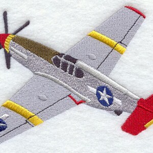 May include: A gray and red embroidered airplane with yellow accents and a star on each wing. The airplane is flying in the air.
