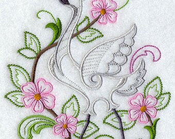 May include: Embroidered design of a white crane with a red head and black beak standing in a garden with pink flowers and green leaves.