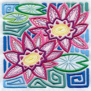 May include: Embroidered design featuring two pink and purple stylized flowers with yellow centers, surrounded by green and blue geometric shapes.