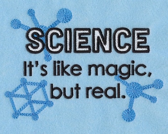 May include: Light blue fabric with the word "SCIENCE" in black and white embroidery. Below, the text reads "It's like magic, but real." Blue molecule-like designs are embroidered around the text.