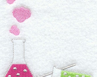 May include: A pink glass beaker with pink dots and a green test tube with white dots. Pink bubbles are rising from the beaker.