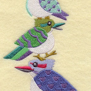May include: Three embroidered birds stacked on top of each other. The top bird is purple and green, the middle bird is green and white, and the bottom bird is purple and pink.