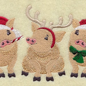 May include: Three embroidered pig ornaments wearing Santa hats. One pig is holding a candy cane, another has antlers and a red headband, and the third has a green bow tie.