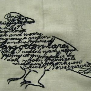 May include: Black embroidered design of a raven with the text "Once upon a midnight dreary, while I pondered, weak and weary, over many a quaint and curious volume of forgotten lore -  While I nodded, nearly napping, suddenly there came a tapping, as of some one gently rapping, rapping at my chamber door."