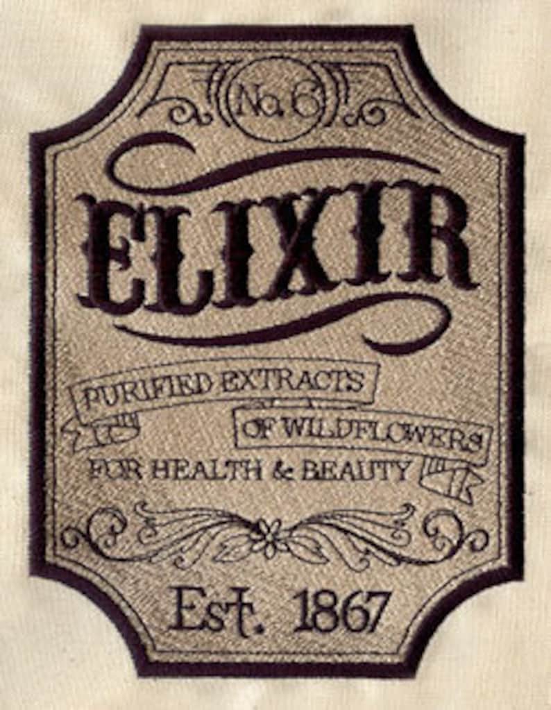 May include: A vintage-style label with the word "ELIXIR" in a decorative font. The label is beige with black text and features the words "Purified Extracts of Wildflowers" and "For Health & Beauty". The label also includes the text "Est. 1867".