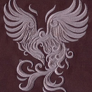 May include: A stylized silver embroidery design of a phoenix with its wings spread wide. The phoenix is depicted in a swirling, intricate pattern.