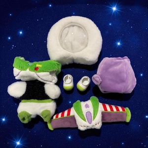 May include: A collection of plush toy accessories, including a white helmet with a clear visor, a green and white Buzz Lightyear costume, two small white and green shoes, a purple headpiece, and a jetpack.