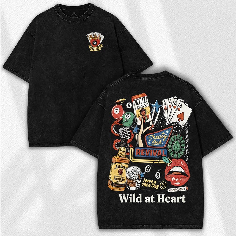 May include: Black graphic tee with a vintage-style design. The front features a playing card symbol with the word "WILD". The back displays a collage of images including playing cards, a bottle of whiskey, and the text "Wild at Heart".