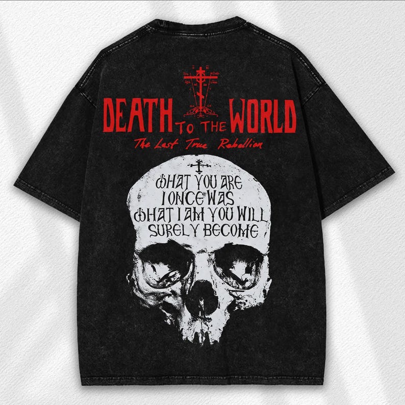 May include: Black oversized t-shirt with a distressed look. The back features red text that reads "DEATH TO THE WORLD" and "The Last True Rebellion." Below the text is a white skull graphic with the words "WHAT YOU ARE ONCE WAS WHAT I AM YOU WILL SURELY BECOME."
