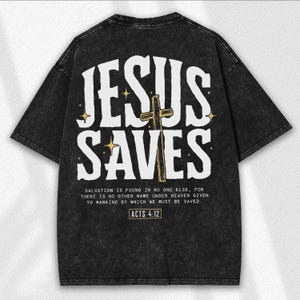 May include: Black t-shirt with the text "JESUS SAVES" in white, featuring a gold cross and stars. Below the text is a quote from Acts 4:12. The shirt has a vintage, distressed look.