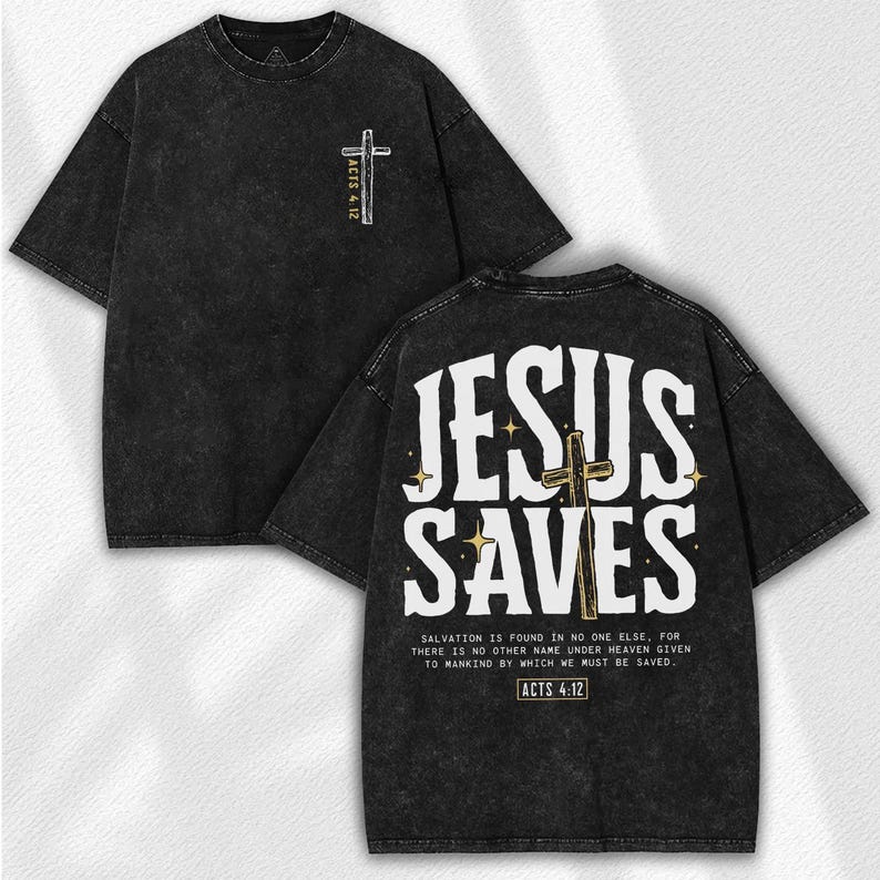 May include: Black, acid-wash style t-shirt with the text "JESUS SAVES" in white on the back, along with a cross graphic. The front features a smaller cross and "ACTS 4:12". The shirt includes a Bible verse.