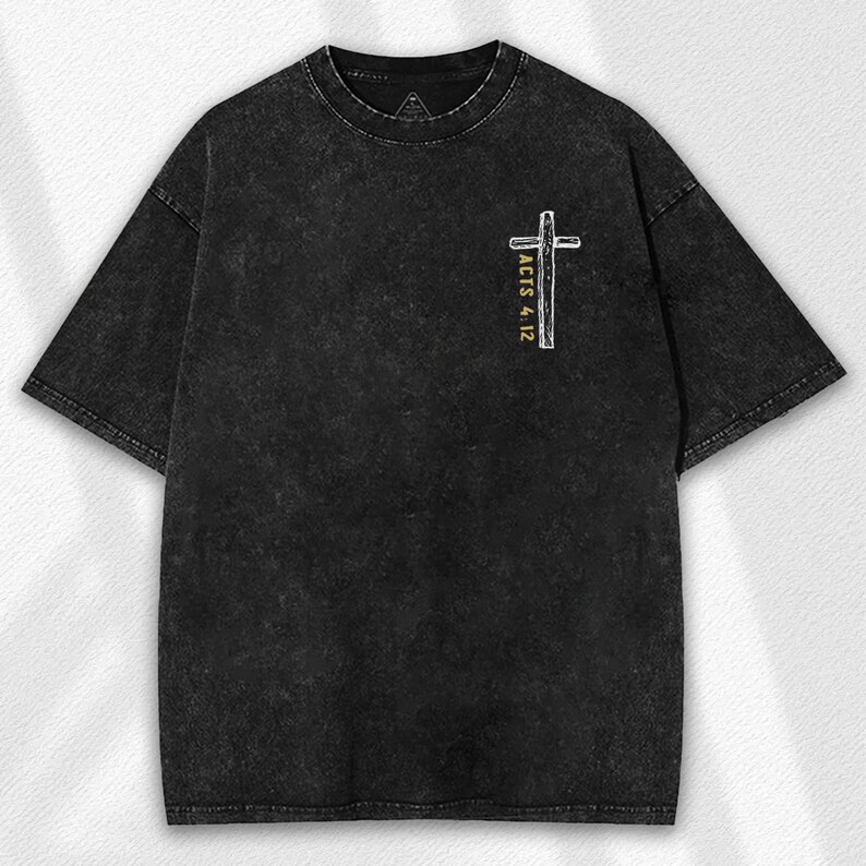 May include: Black, stone-washed t-shirt with a crew neck. The shirt features a white and yellow cross graphic on the front, with the text "ACTS 4:12" printed vertically alongside the cross. The shirt has short sleeves.