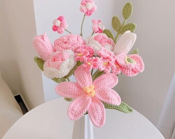 May include: A handmade crochet bouquet of pink and white flowers in a white vase. The bouquet includes various flower types, such as tulips and daisies, with green leaves. The vase sits on a white table. The text "Pattern PDF" is visible.
