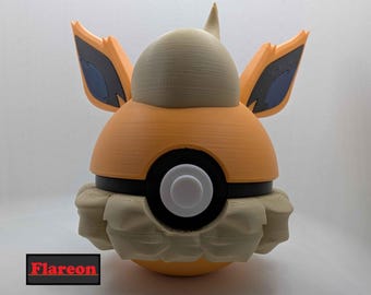 May include: A 3D-printed Flareon figure, featuring a spherical orange body with tan accents and blue details on the ears. The figure has a black and white circular element in the middle and the word "Flareon" in a red and black rectangle.