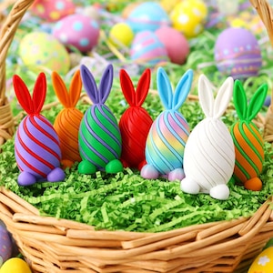 May include: A wicker basket filled with green shredded paper and colourful Easter egg decorations. The eggs are bunny-shaped with striped patterns in various colours, including red, purple, and green.