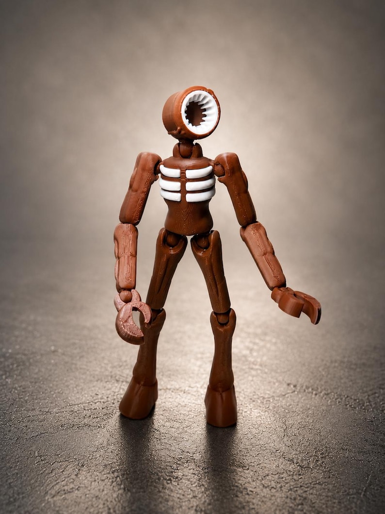 May include: A brown Siren Head action figure with a cylindrical head and a white, toothed opening. The figure has articulated limbs and a skeletal chest design. The figure is standing on a textured surface.