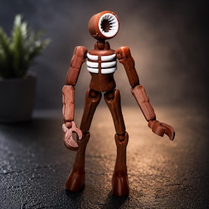 May include: A brown Siren Head action figure with a cylindrical head and a white speaker-like opening. The figure has articulated joints and a skeletal chest design. The figure is posed on a dark, textured surface.