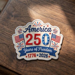 May include: Embroidered patch with the text "America 250 Years of Freedom 1776-2026". The patch features the American flag, fireworks, and the number 250 in red and blue. The patch has a cream-colored border.